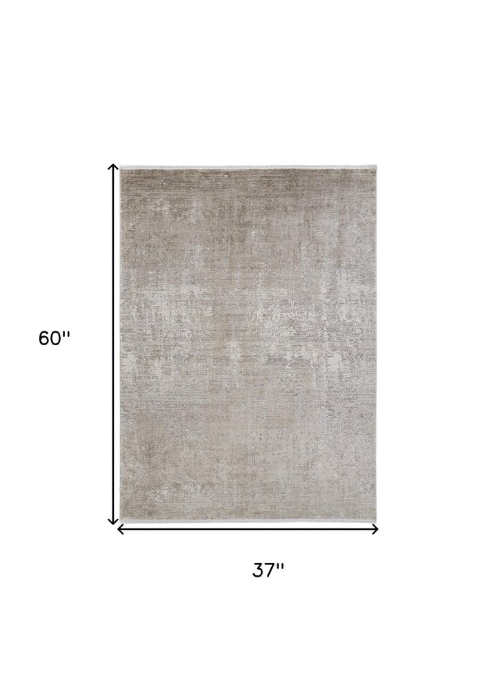 3' X 5' Tan and Ivory Abstract Power Loom Distressed Area Rug With Fringe