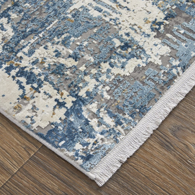 3' X 5' Ivory Tan and Blue Abstract Power Loom Area Rug With Fringe