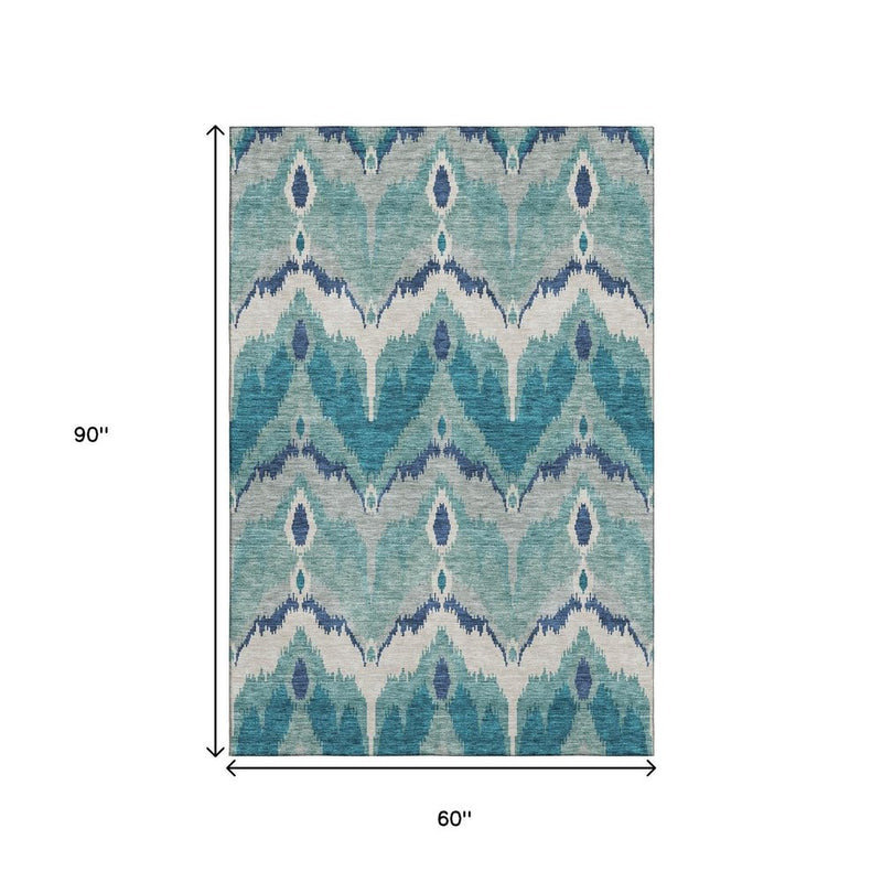 5' X 8' Teal And Ivory Ikat Washable Area Rug With UV Protection