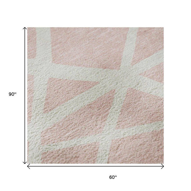 5' X 8' Pink And Ivory Geometric Washable Area Rug With UV Protection